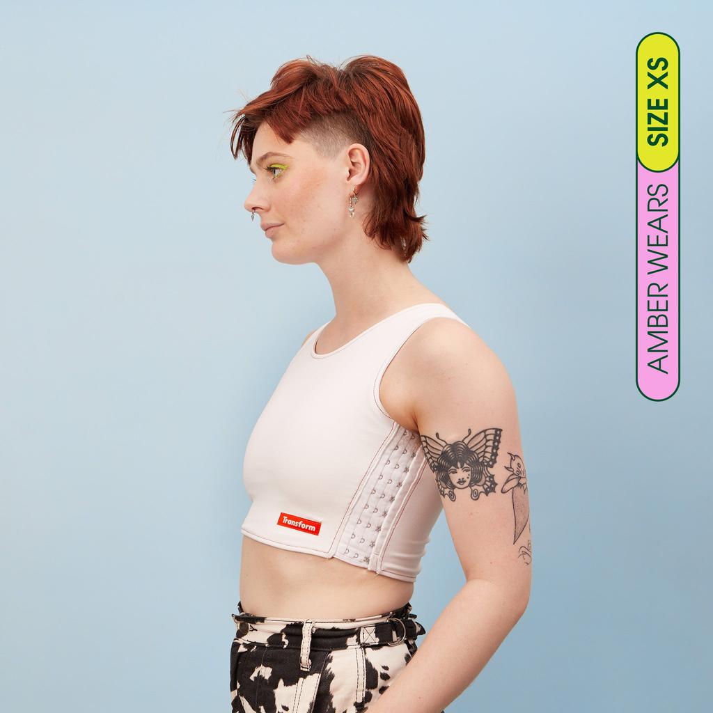 Amber wearing our maximum compression, adjustable and breathable chest binder - side view showing flattening effect