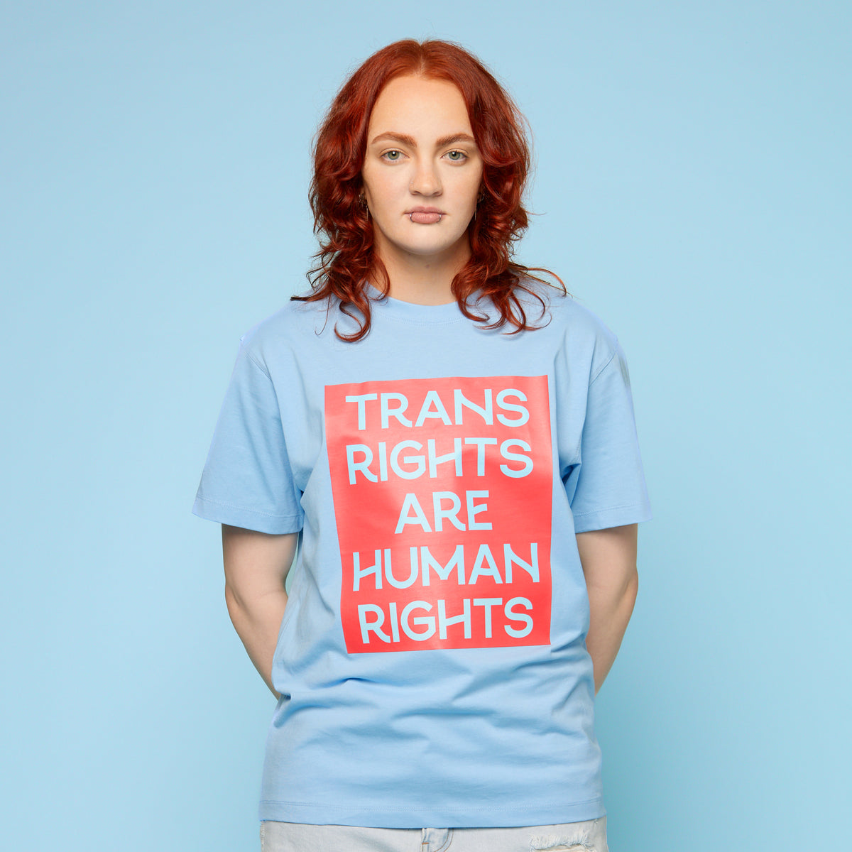 Person wearing a pride t-shirt with the words &#39;trans rights are human rights&#39; - front view
