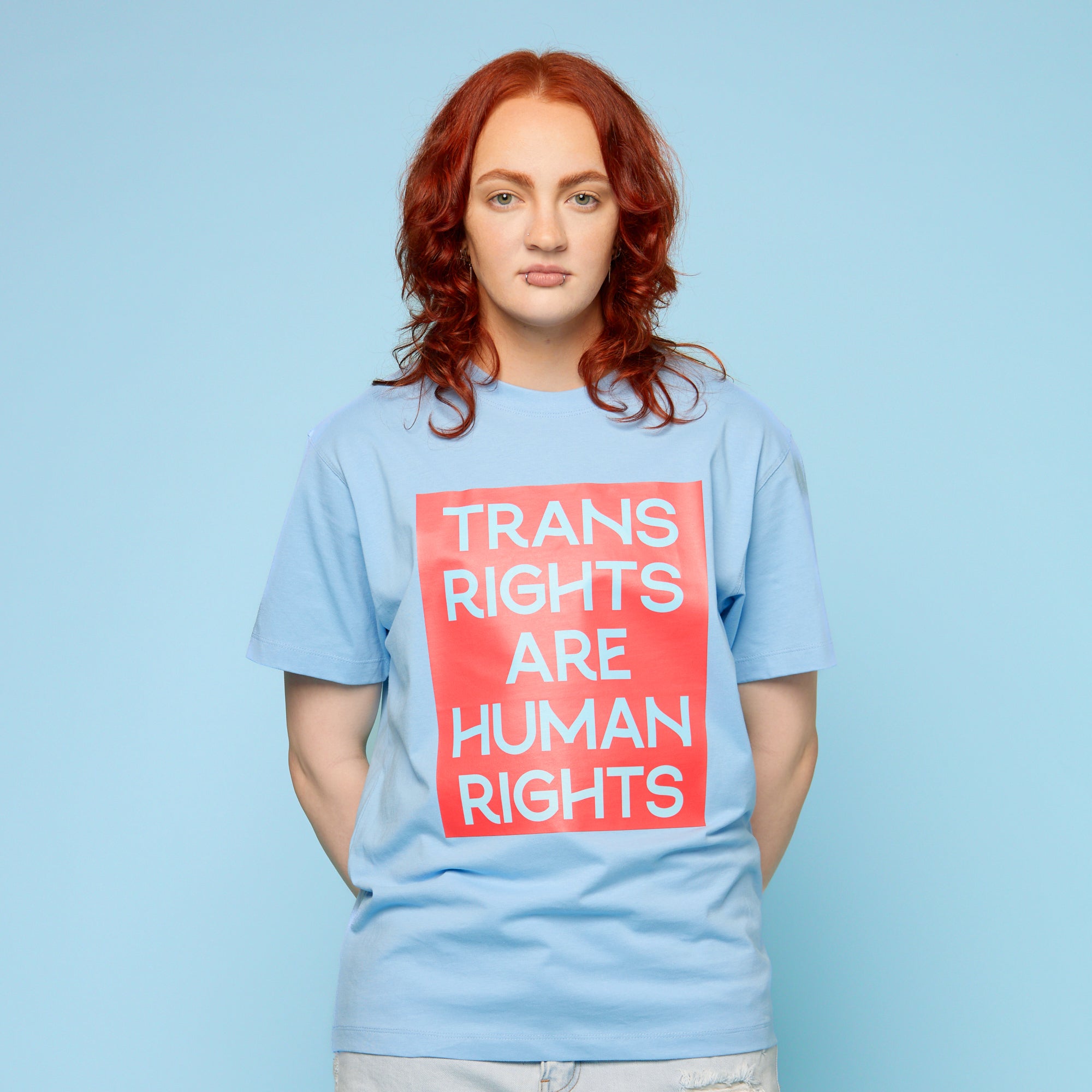 Person wearing a pride t-shirt with the words 'trans rights are human rights' - front view