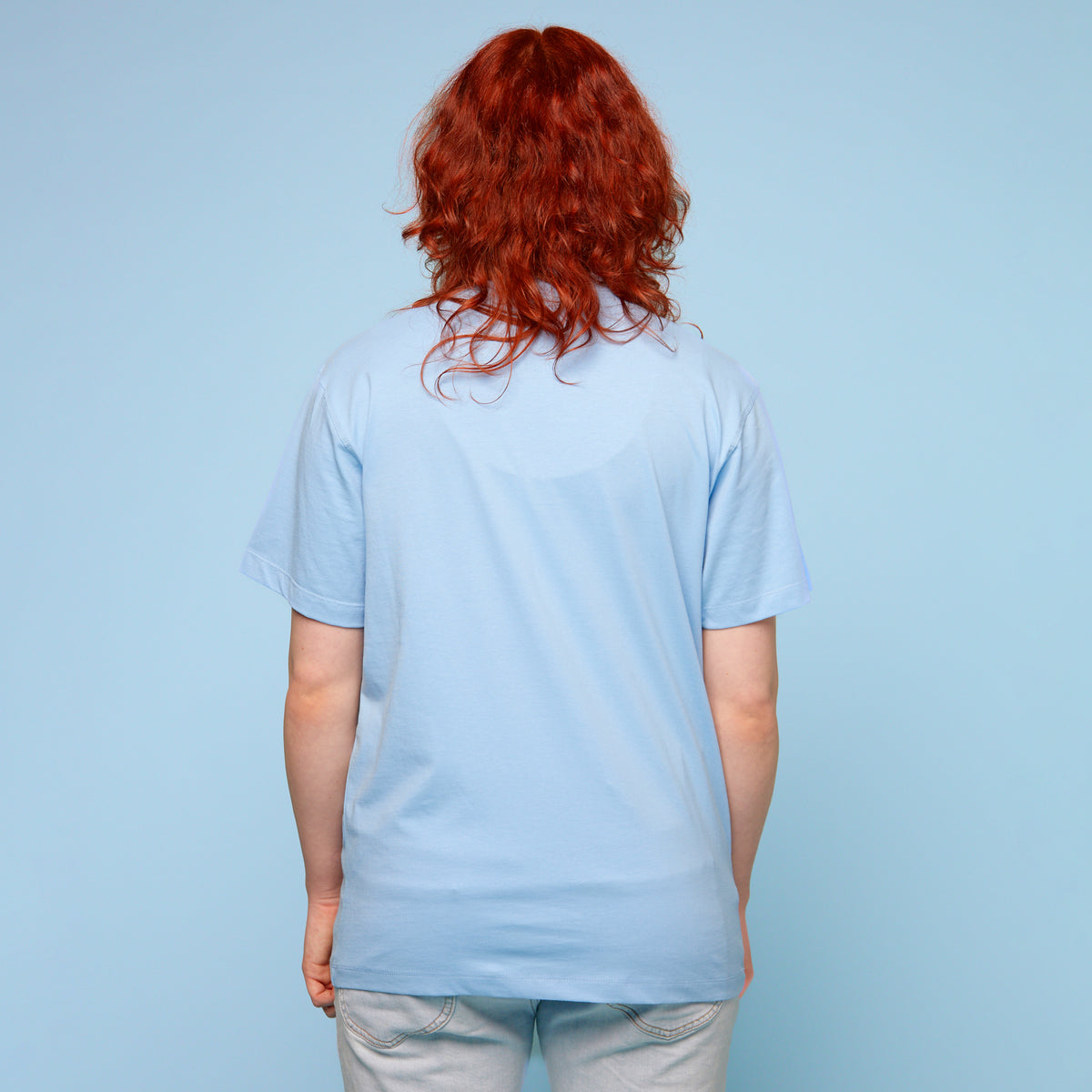 Person wearing a pride t-shirt with the words &#39;trans rights are human rights&#39; - rear view