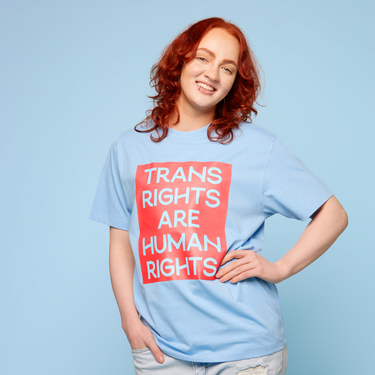 Person wearing a pride t-shirt with the words &#39;trans rights are human rights&#39; - front view