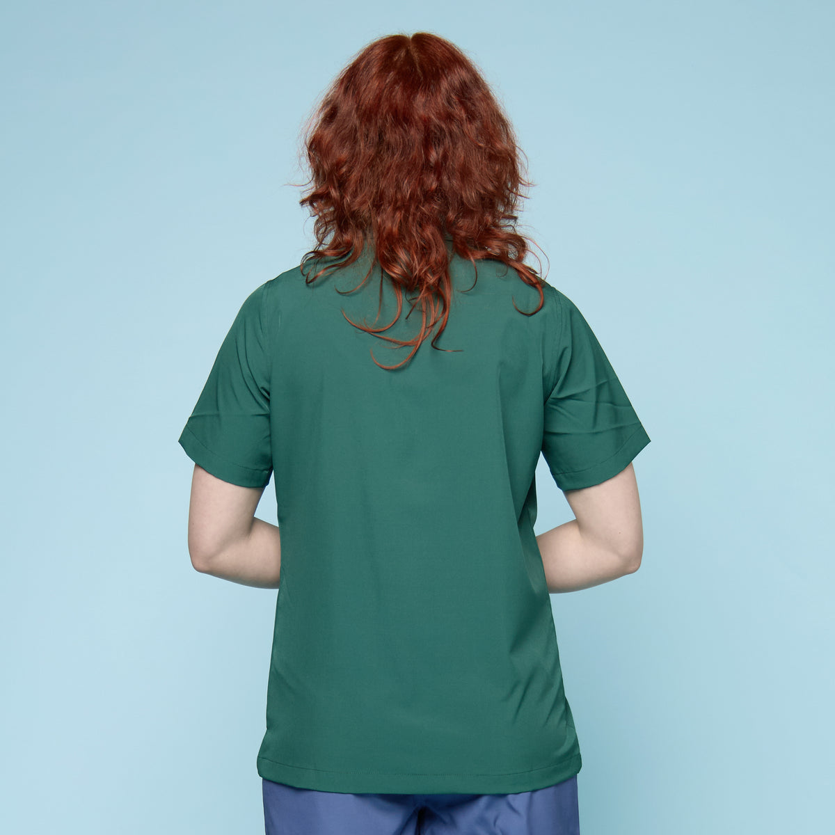 Person wearing a green button up swim shirt with a collar - rear view