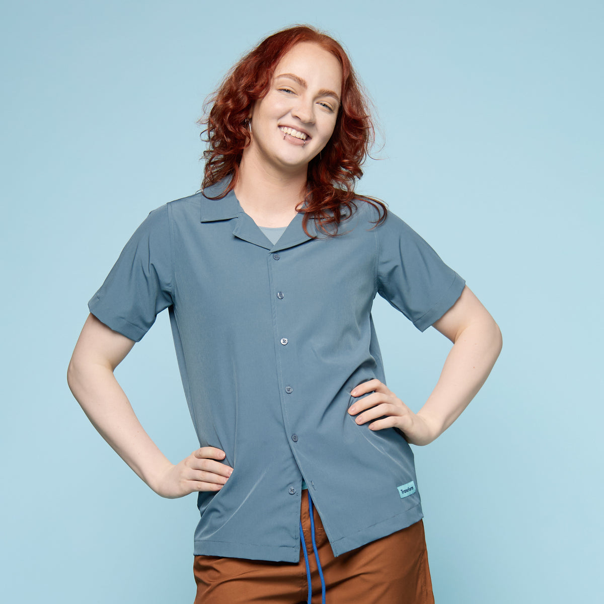 Person wearing a blue button up swim shirt with a collar 