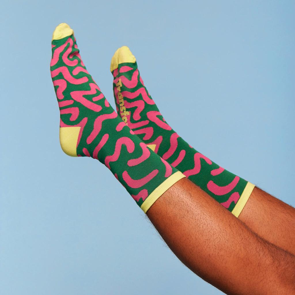 Model wearing a pair of pride socks