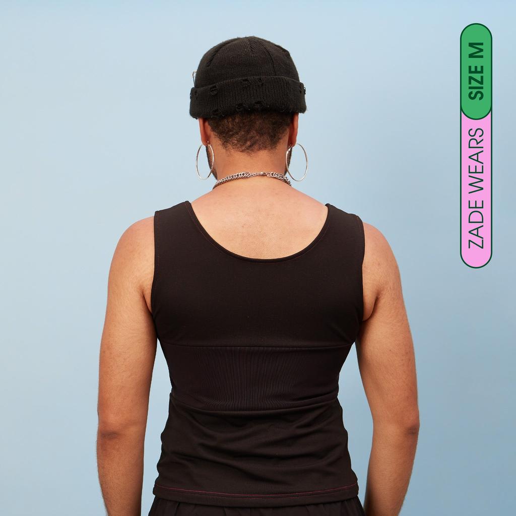 Zade wearing black, breathable tank chest binder - Rear View showing breathable panel